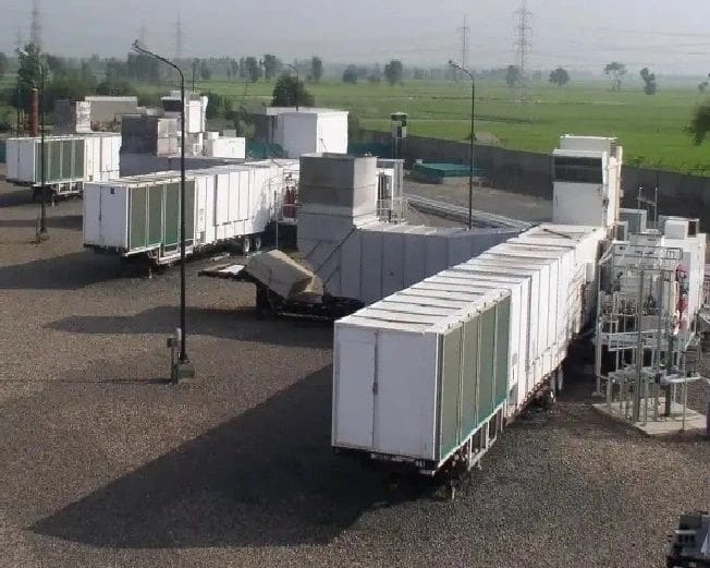 A group of trucks parked in the middle of an open field.